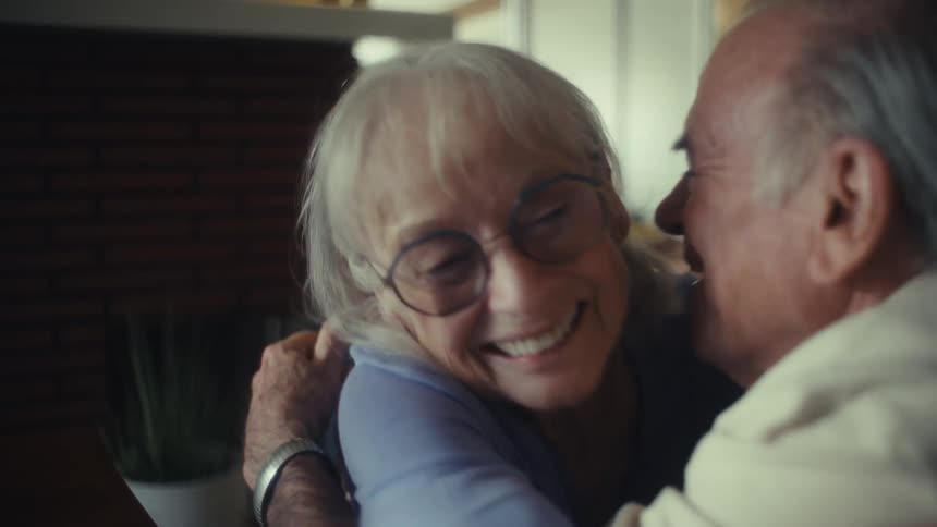 A woman gets excited and hugs a man