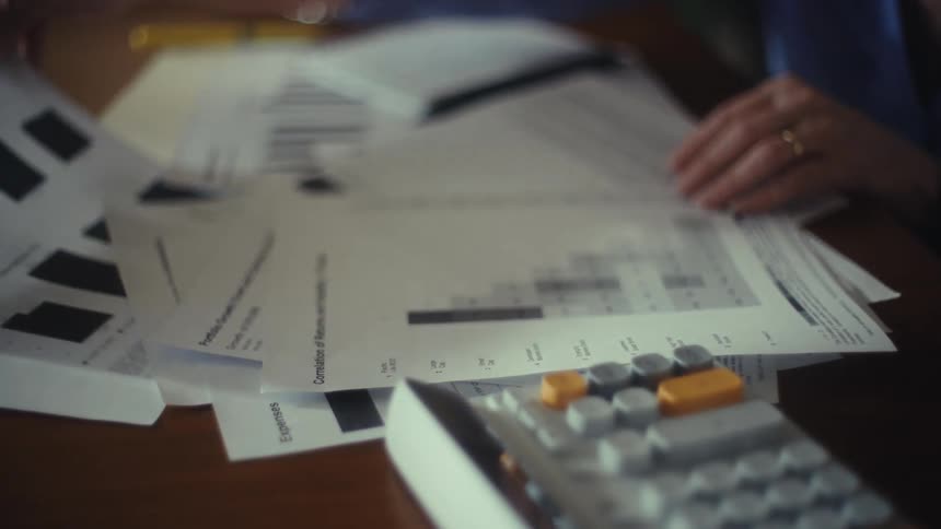 People consult documents while working at a desk together