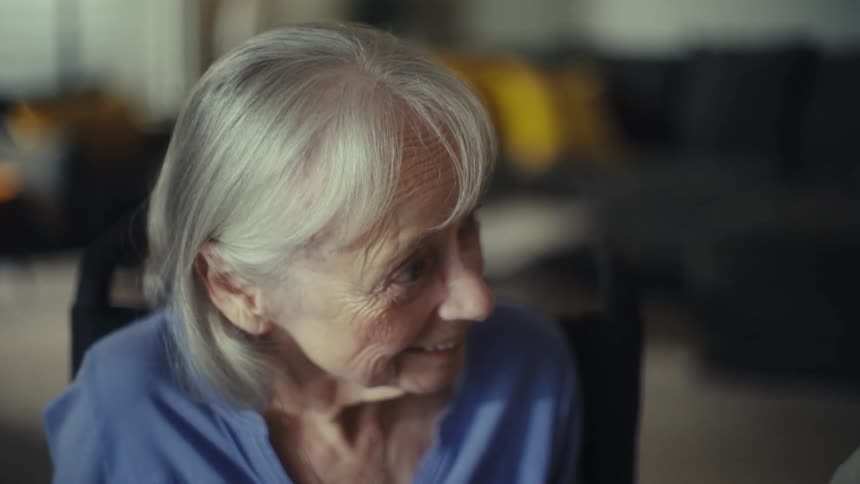 Elderly couple sitting at the dining table at home reviews paperwork