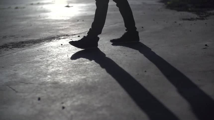 Man walking over pavement