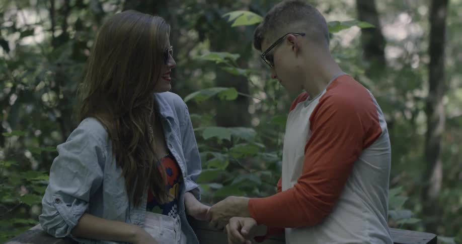 Man and woman having a flirtatious time in a forest