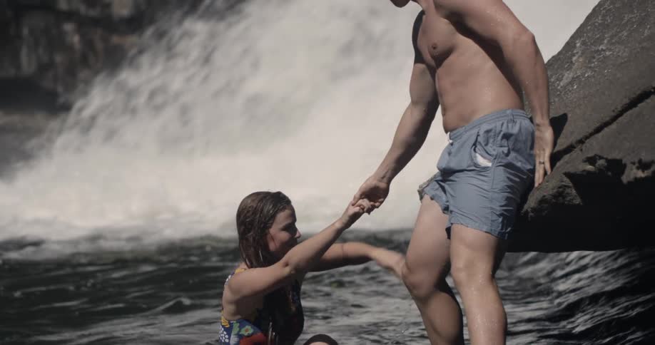 A man helps a woman out of the water