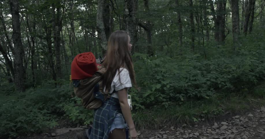 A man and woman walk through a hiking trail