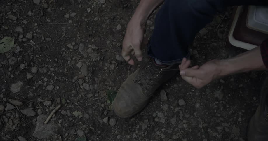 A person ties their boots