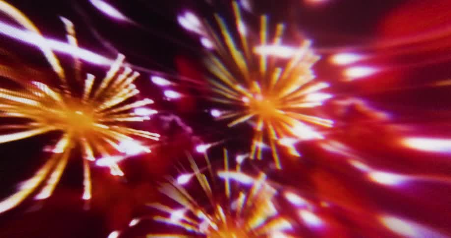 Fireworks burst in the dark night sky illuminating the atmosphere with different colors and patterns of light