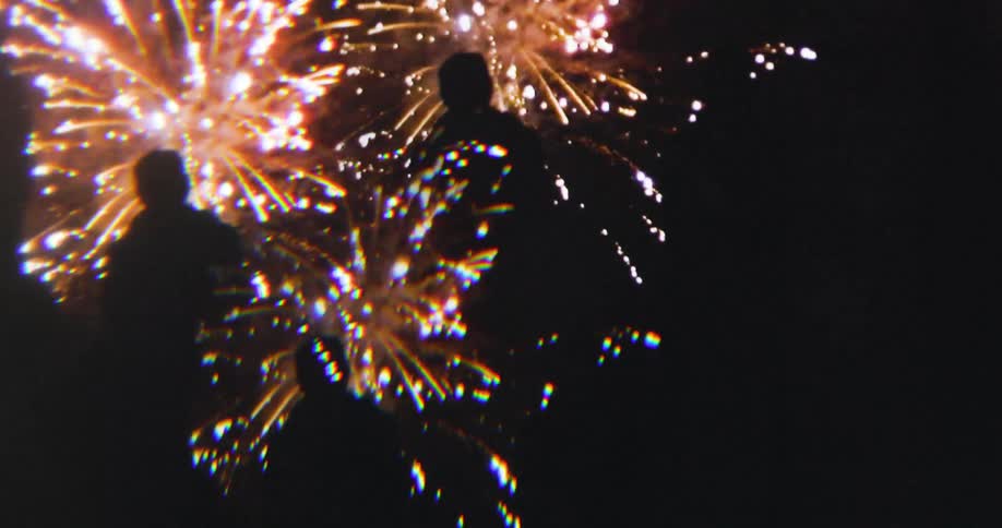Group of people watch golden fireworks
