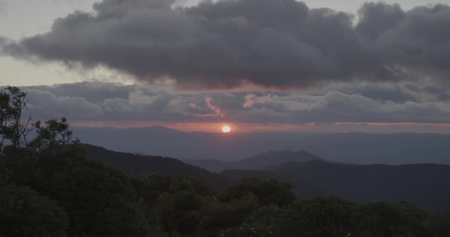 The sun is setting in the distance over the mountains