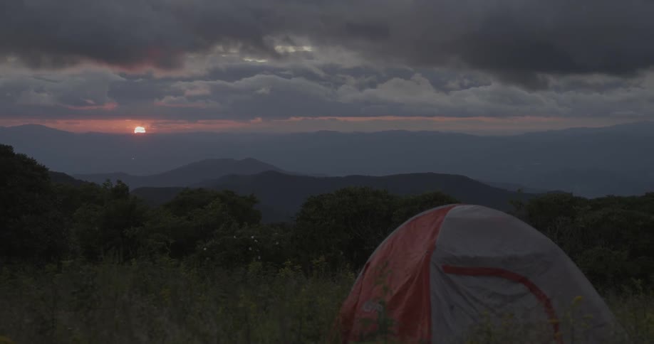 Tent set up in wilderness at sunset