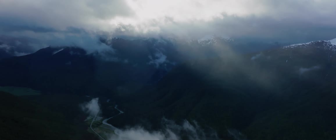 A aerial view of a breathtaking mountain view clouds are passing by and it looks very beautiful
