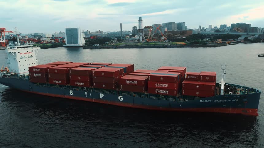 Ship with containers sailing across the ocean