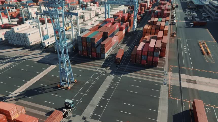Trucks moving cargo containers through a container yard