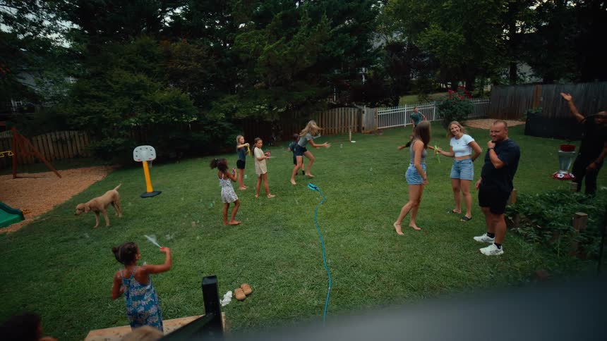 A crowd are having fun in the backyard