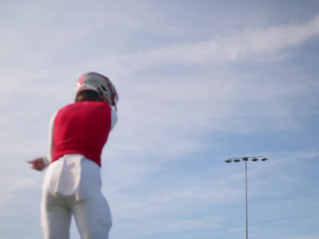 A young football player throwing an american football