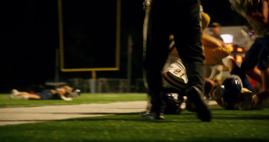 Football player getting tackled out of bounds