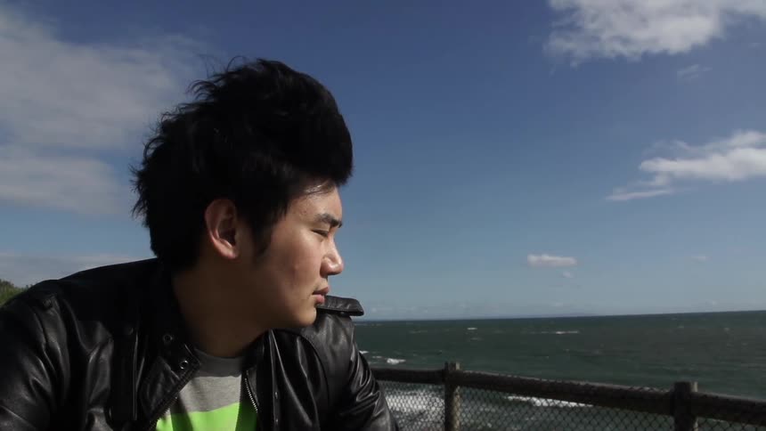 Man sitting with his eyes closed enjoying the blowing breeze