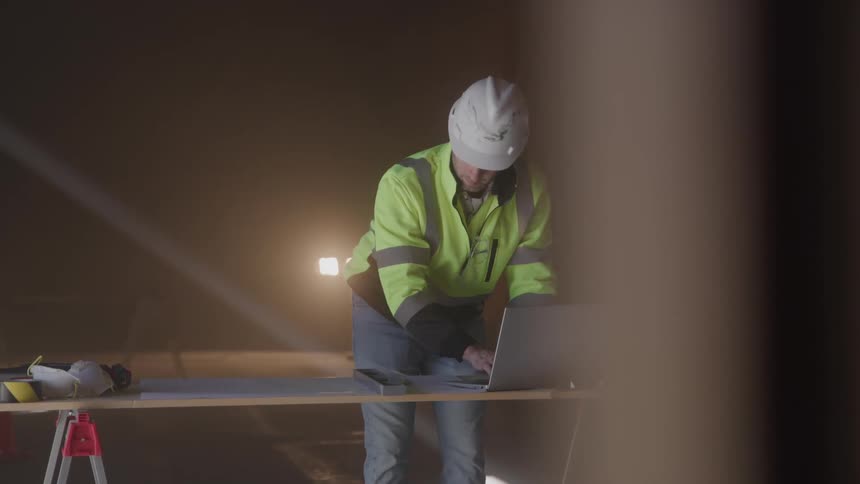 Civil engineer typing on a laptop