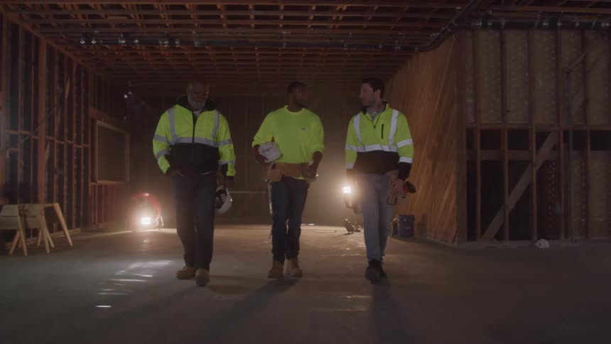 The construction workers walk and talk