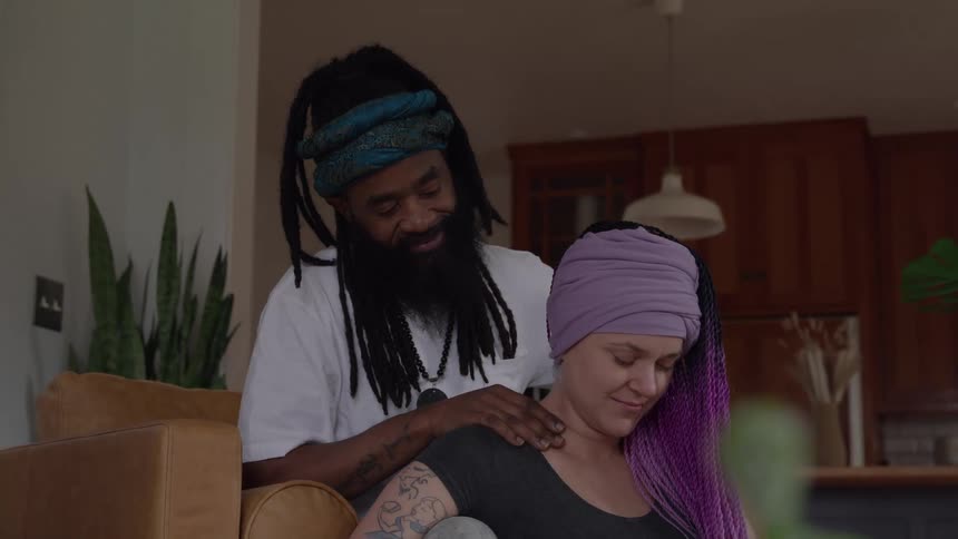 A man is massaging a womans shoulders