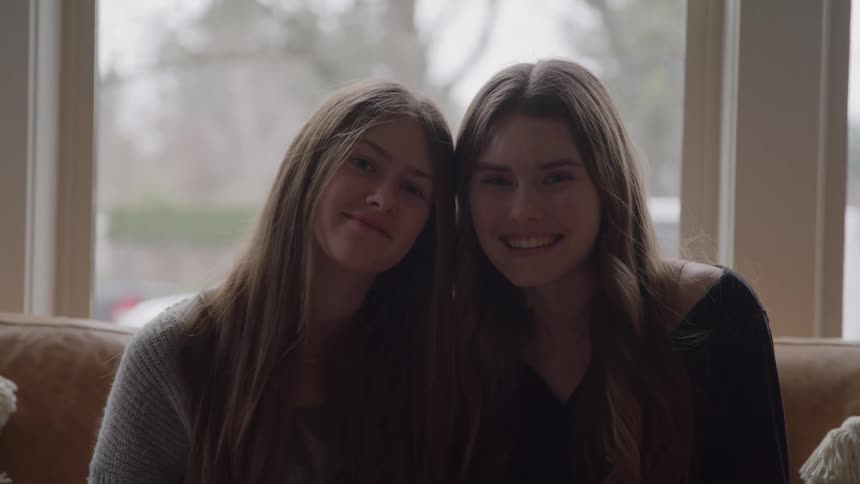 Two young women sitting side