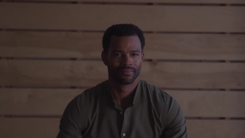 A man standing still staring straight ahead