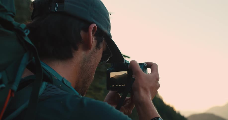 Man with a backpack captures the landscape using a camera