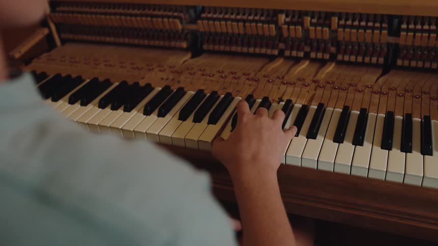 Person sitting playing piano