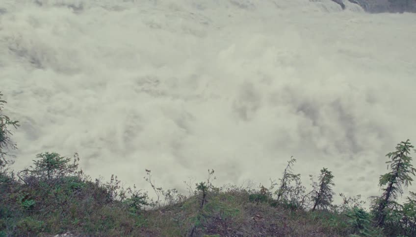Whitewater crashes through a powerful river rapid