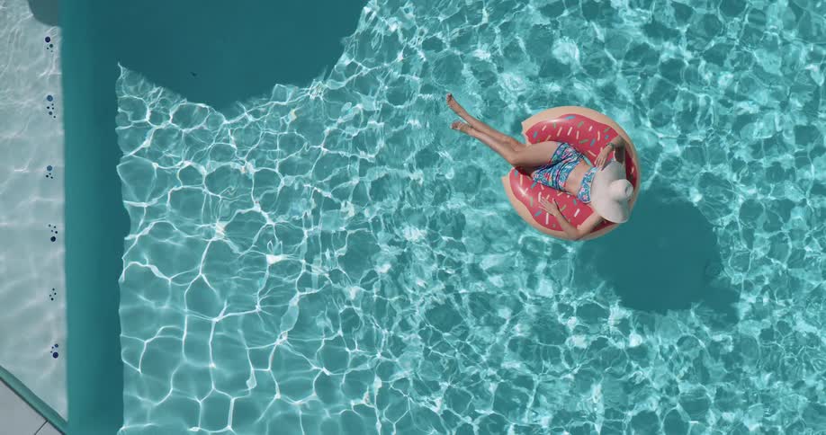 Woman lying on a float in the pool