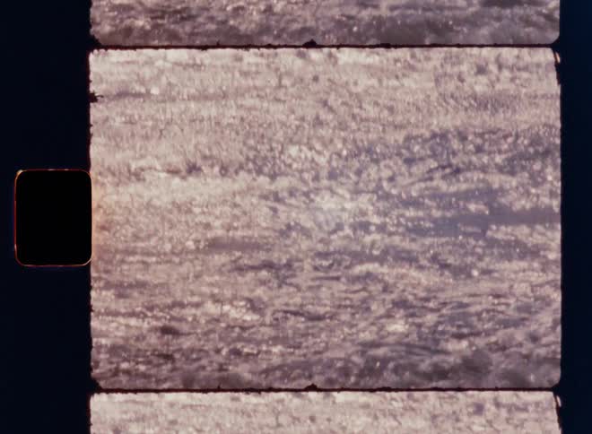 The video shows two horizontal lines of white sea foam and water moving towards the right the lines are separated by a dark vertical line and are accompanied by a faint filmsupply watermark in the center