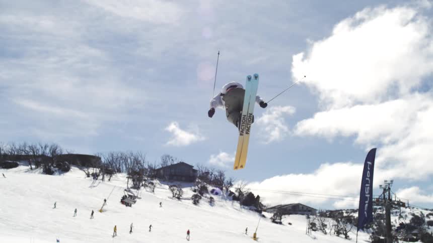 Skier performing a jump on a snowy slope