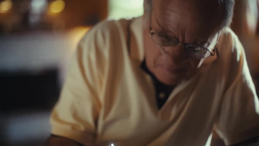 The man is filling out a form with a pen