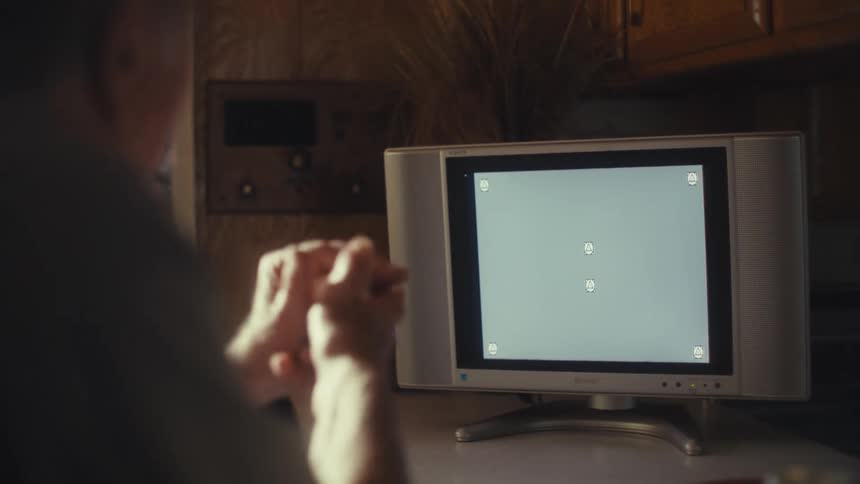 The man is having fun watching television at home