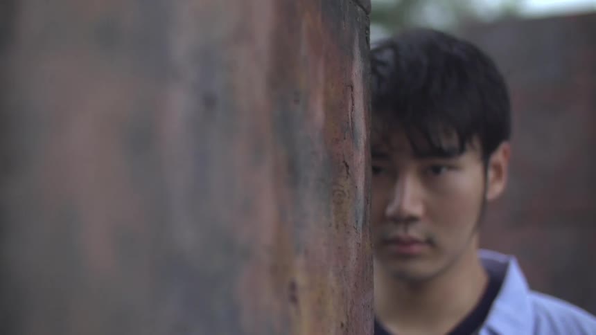 Man slowly coming out from behind a corner