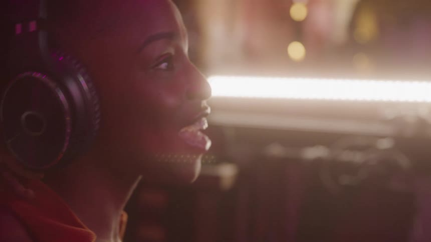 Woman with headphones enjoying music in a studio