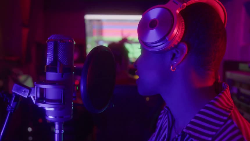 Woman singing recording music in a studio