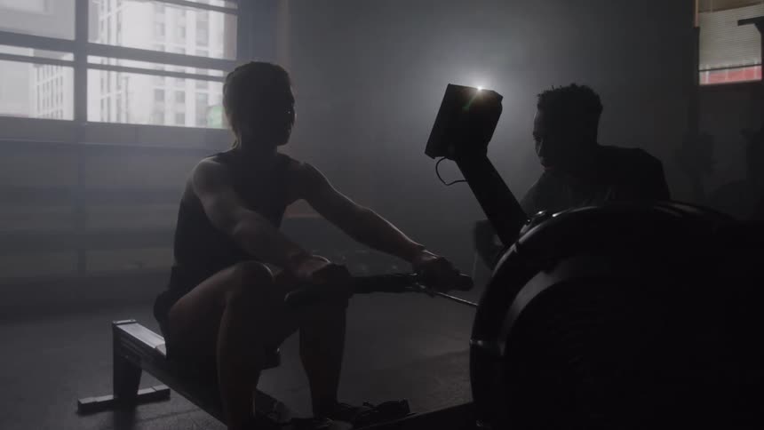 Woman training on a rowing machine at the gym