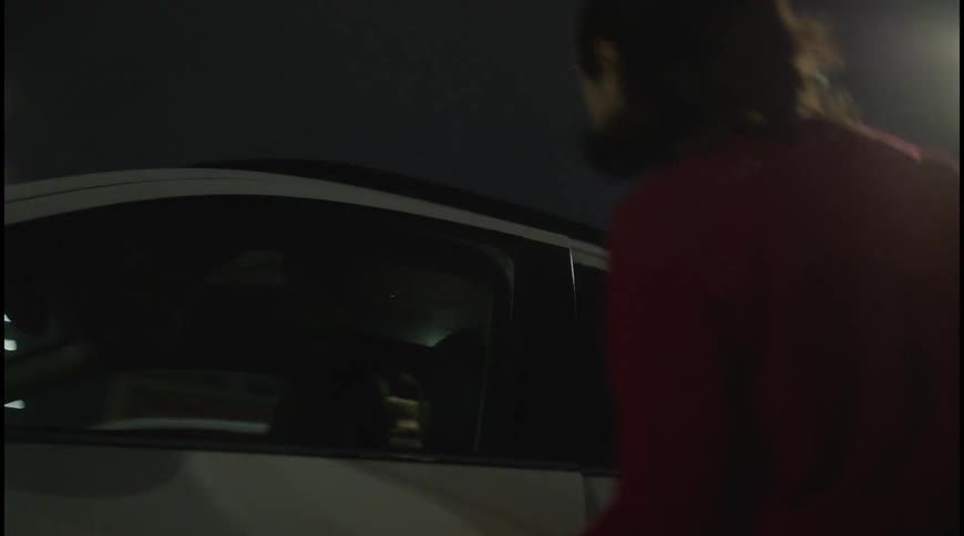 The woman walks to her car in the parking lot