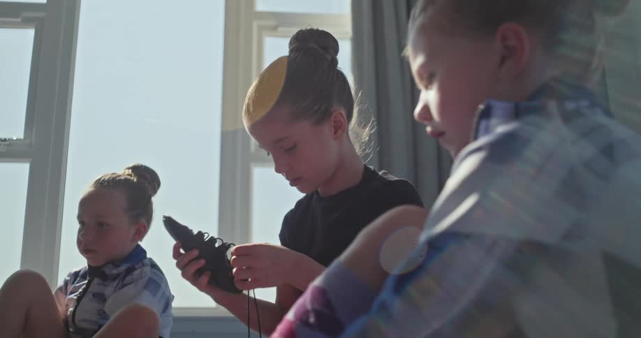Girls are putting on shoes together