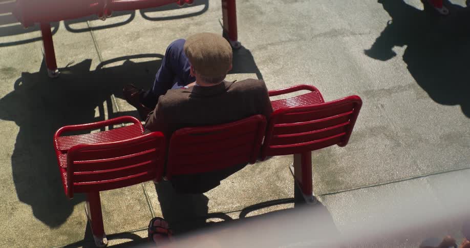 Man in beret sitting on a red chair