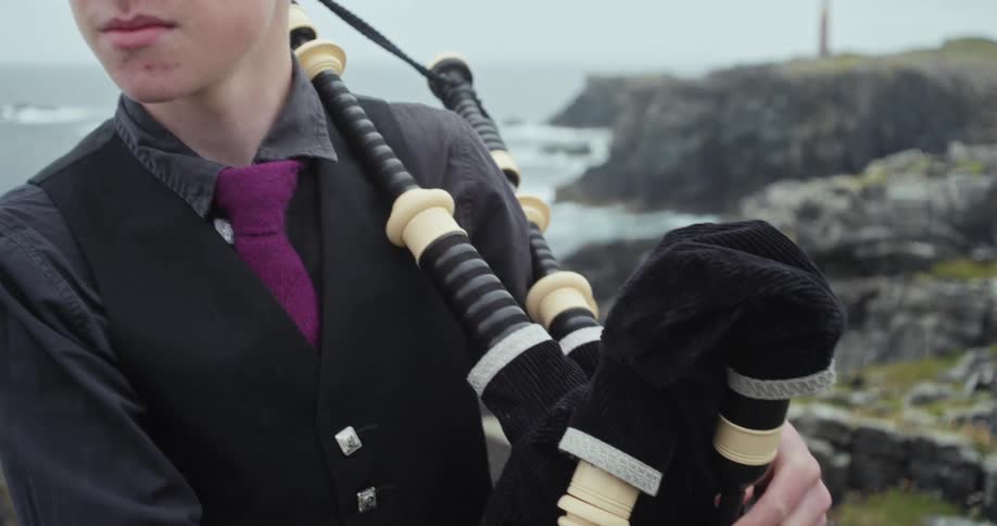 Young man with a musical instrument on the seashore