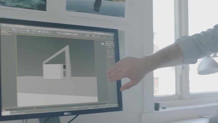 Two people look at a computer at work