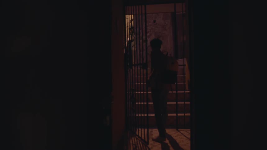 A person walks through an iron gate