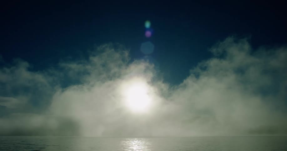 The fog moves over the water