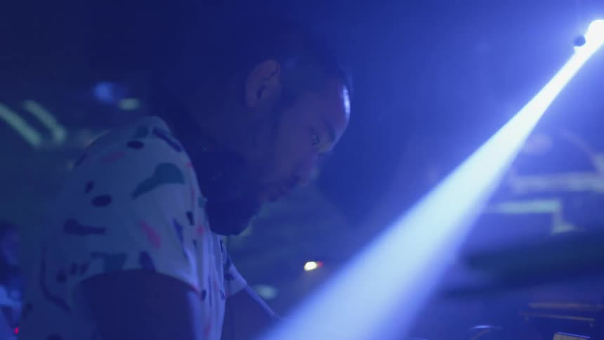 A dj dances in a nightclub