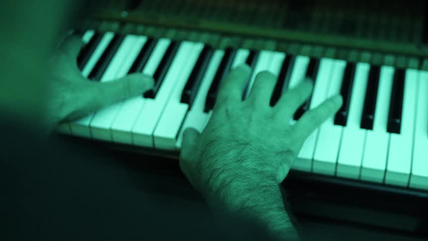 The man is playing the piano