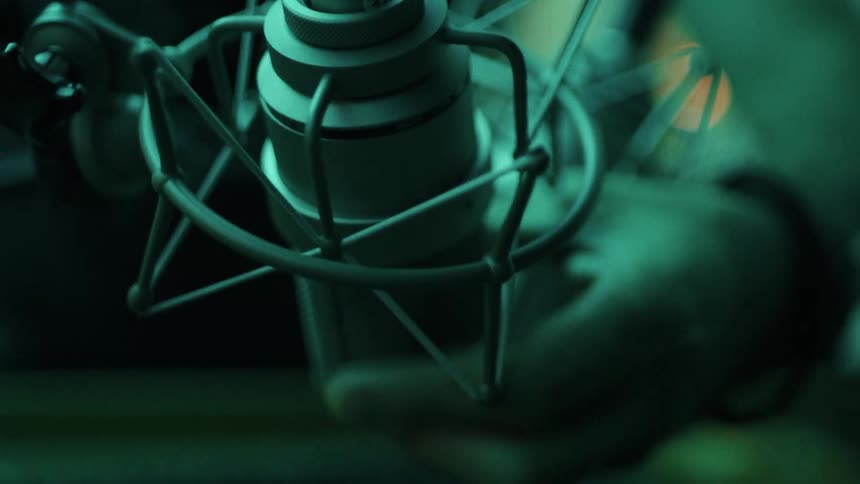 Man attaches a microphone into a stand