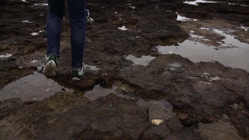 Person walking over some rocks