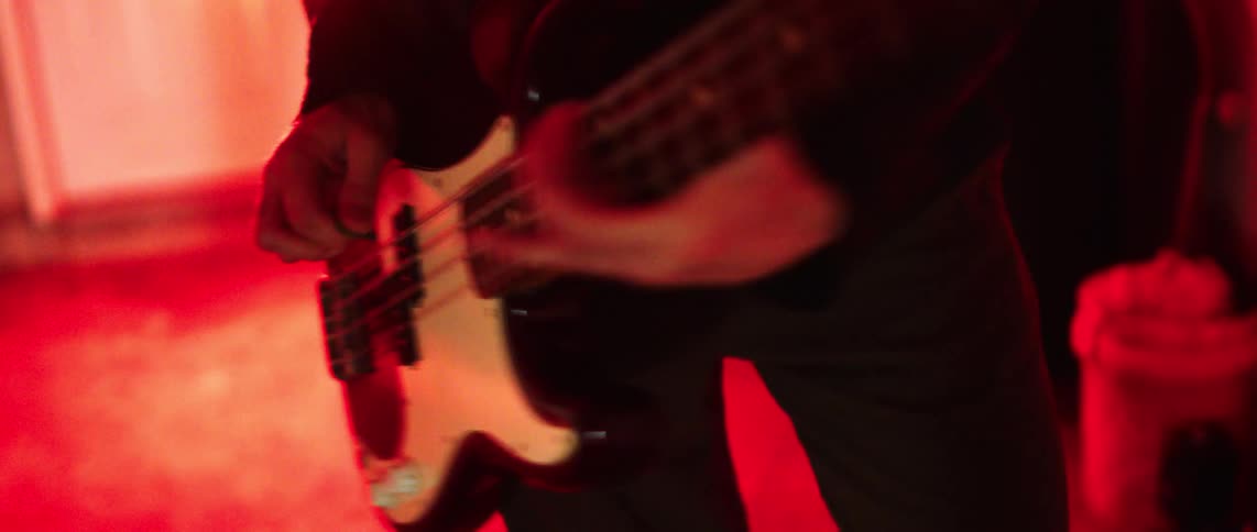 The man is playing the guitar