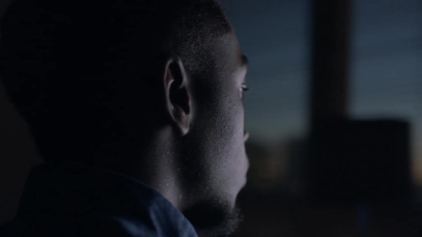 A man looks at a computer screen