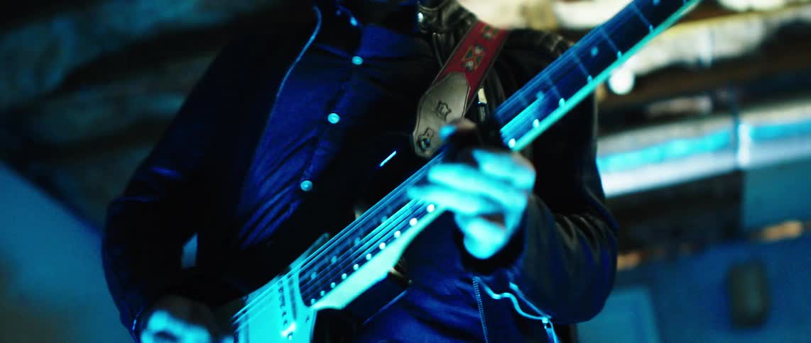 Man plays the guitar during a rock band performance